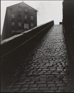 Bill Brandt (1904-1983) is widely considered to be one of the most important British photographers of the 20th century. He is known to have visited Halifax on numerous occasions. Yesterday on a visit to Halifax to view the @rpsanalogue 10th Anniversary exhibition I joined a photowalk which took in three of his locations. This is one of them and is entitled 'Snicket' 
1st image © Bill Brandt 1936. 
2nd image is mine 18 April 2026. 
My image is taken with a digital camera. I'm still waiting for my analogue images to be developed.

#rps #monochromephotography #blackandwhitephotography #rpscontemporarygroup #rpsanaloguegroup